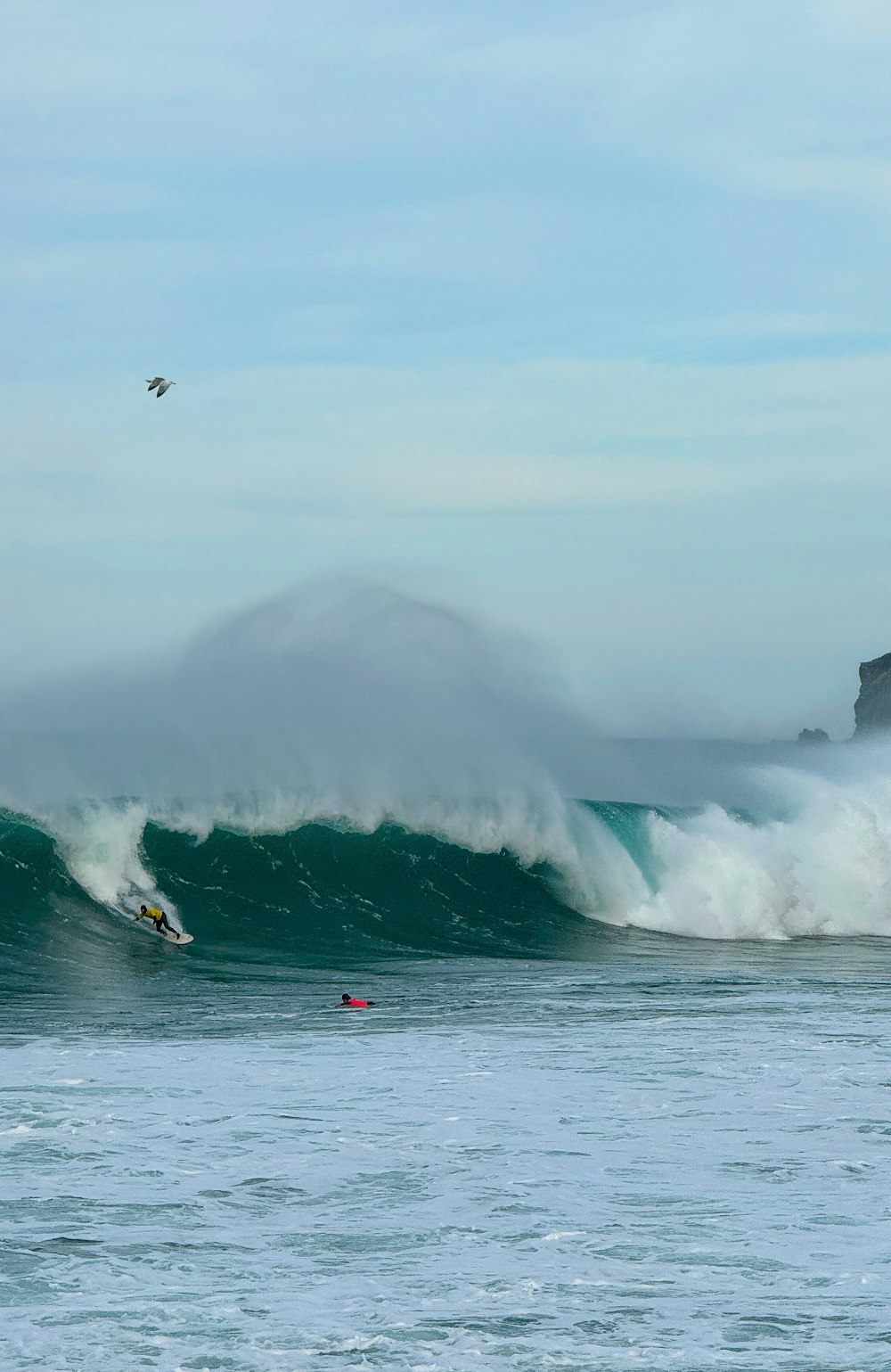 a person riding a surfboard on a wave in the ocean