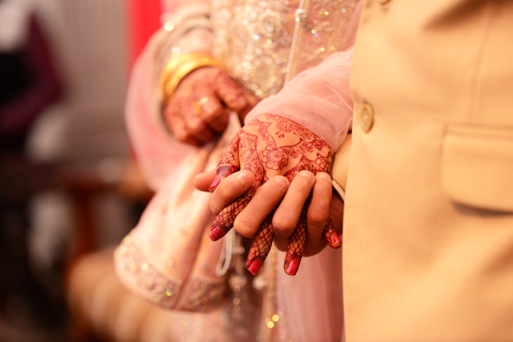 a close up of a person with henna on their hands