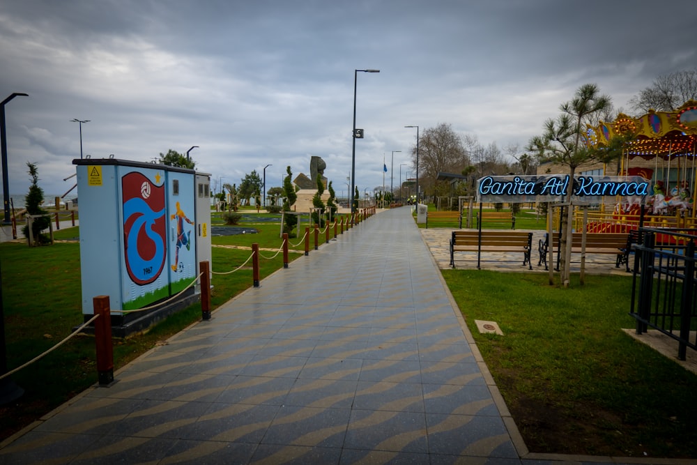 a walkway leading to a carnival park