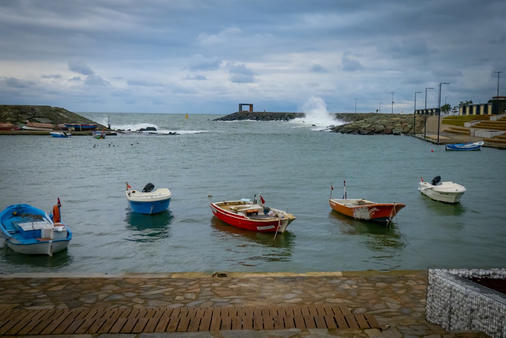 a group of small boats floating on top of a body of water