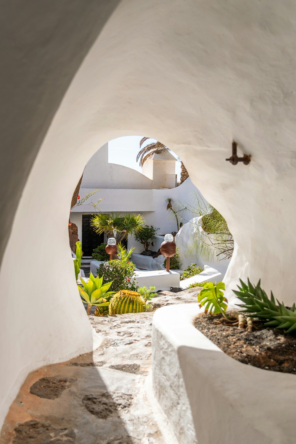 a view of a white building through an archway
