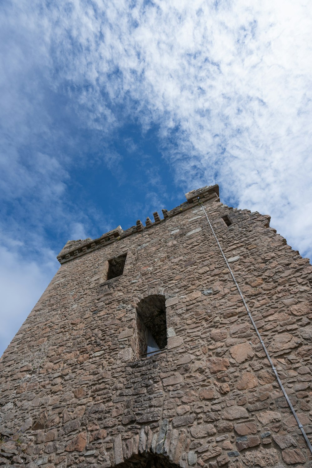 a very tall brick building with a sky background