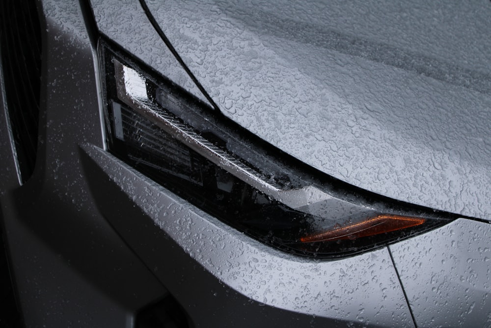 a close up of the front of a car covered in snow