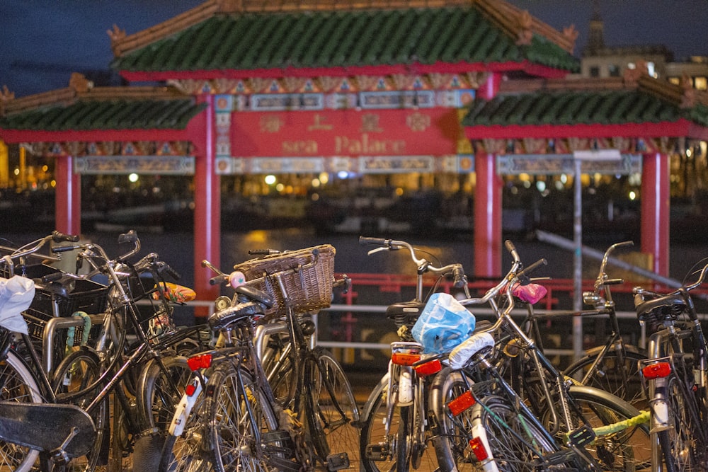 a bunch of bikes parked in front of a building