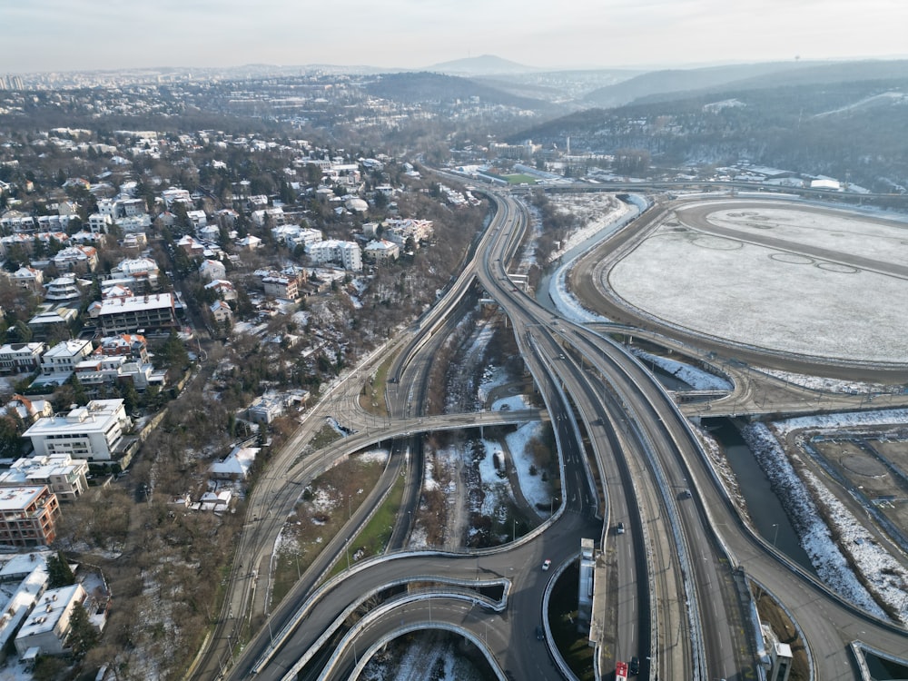 an aerial view of a highway intersection in winter