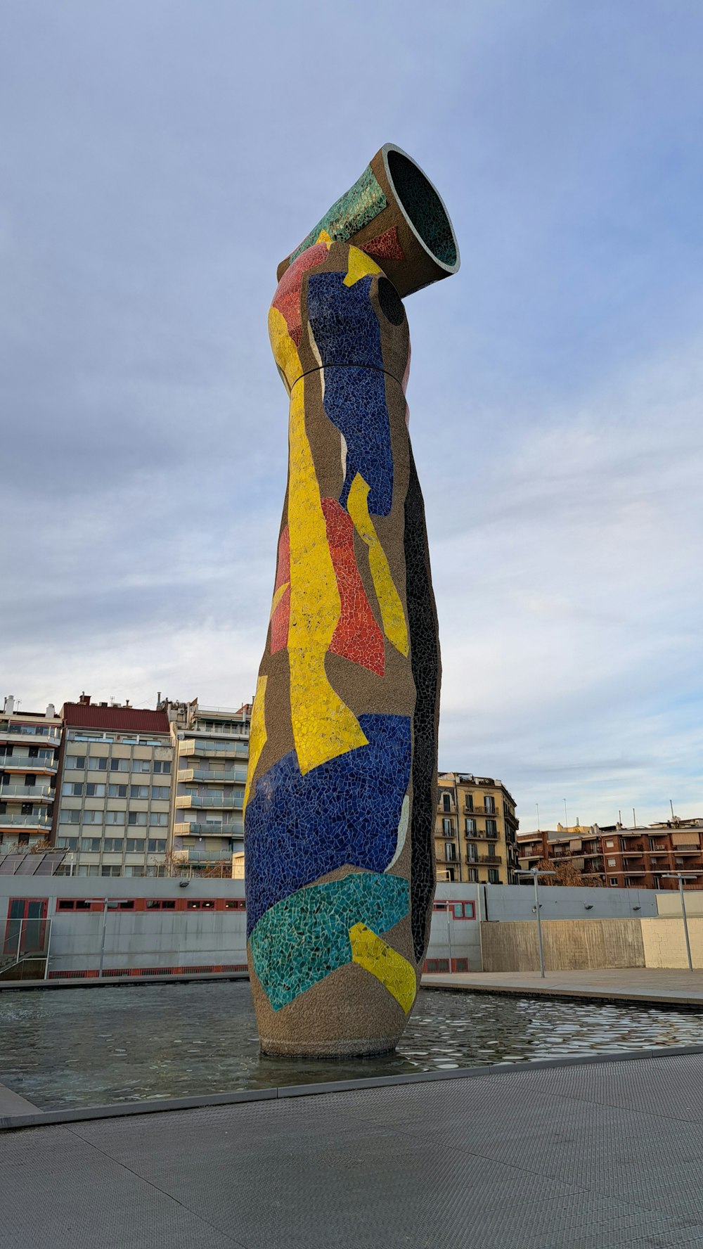 a large piece of art sitting on top of a cement slab