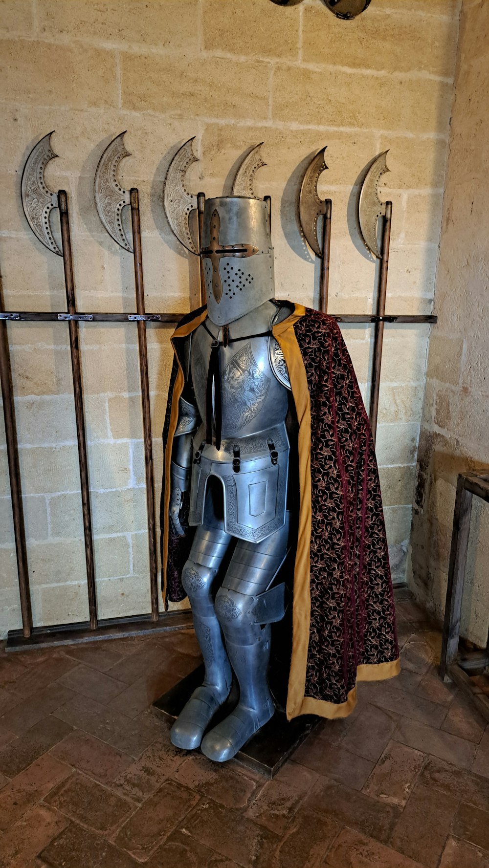 a suit of armor sitting on top of a stone floor