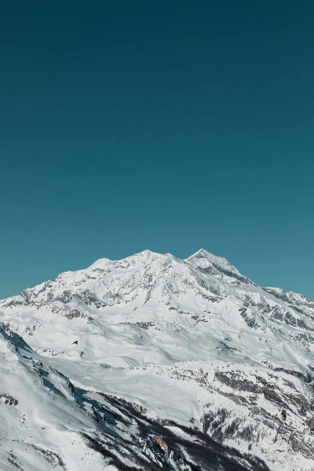 a person riding skis on top of a snow covered slope