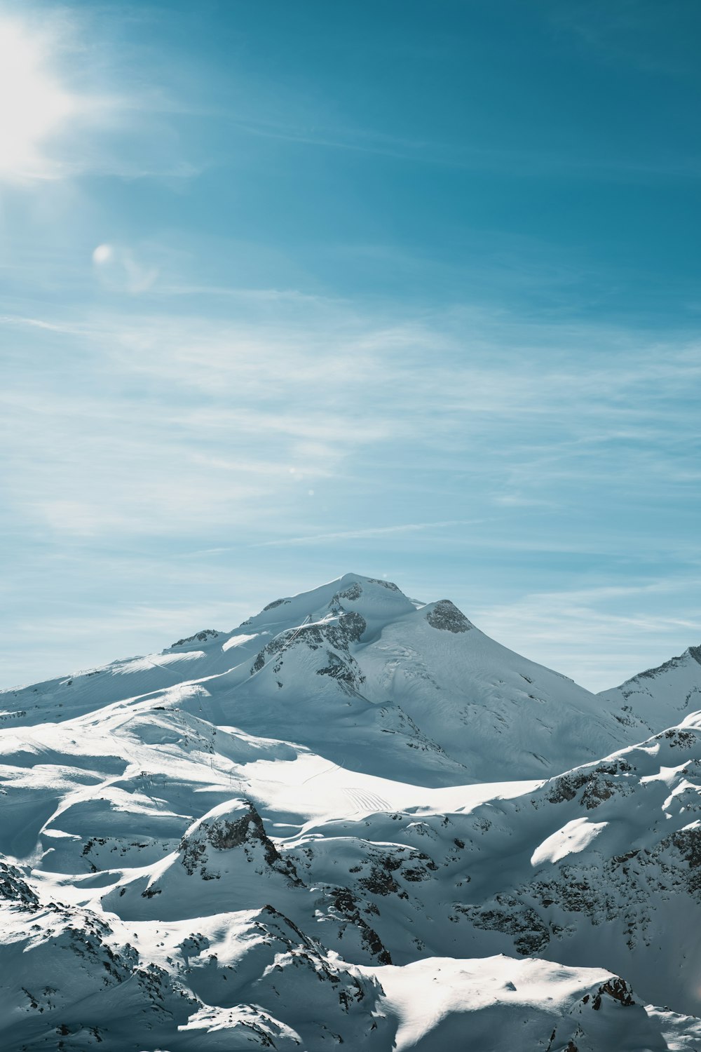 a snow covered mountain with a sky background