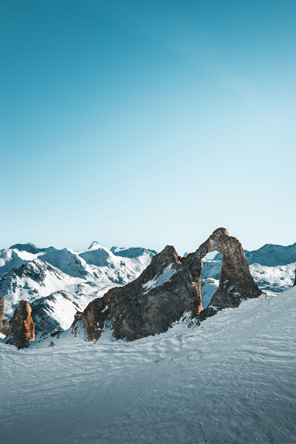 a man riding skis on top of a snow covered slope