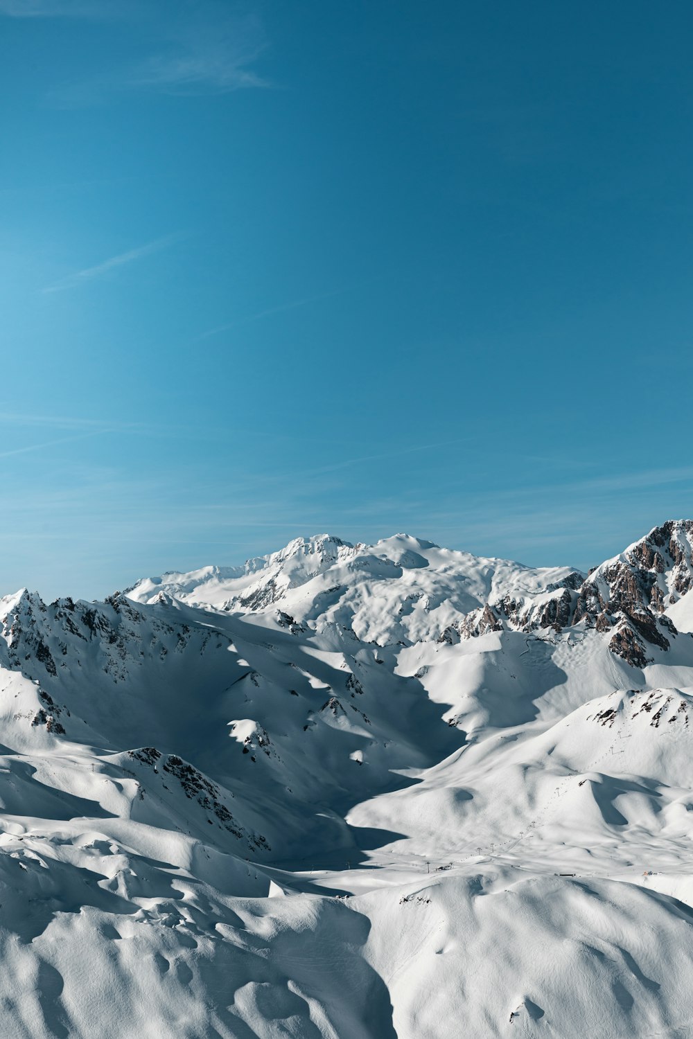 a person riding skis on top of a snow covered slope