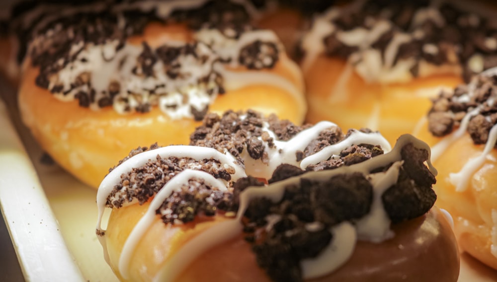 a close up of a tray of doughnuts with toppings