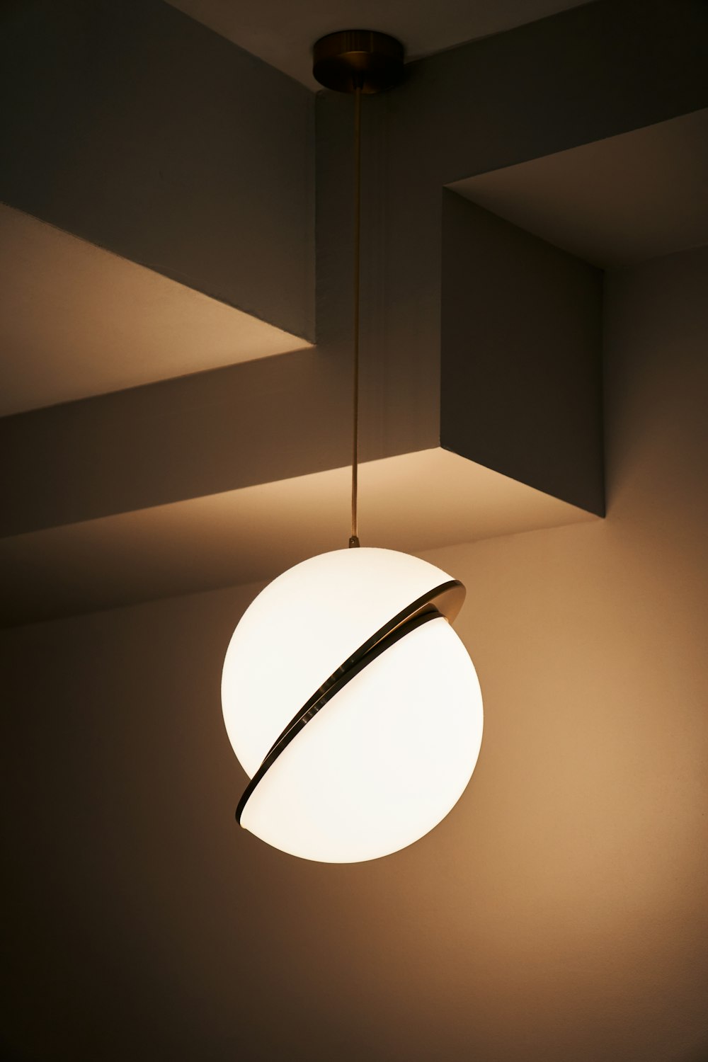 a white light hanging from a ceiling in a room