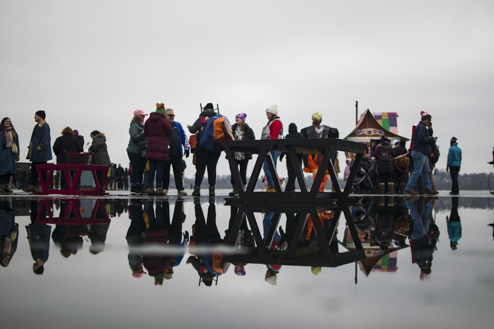 a group of people standing on top of a lake