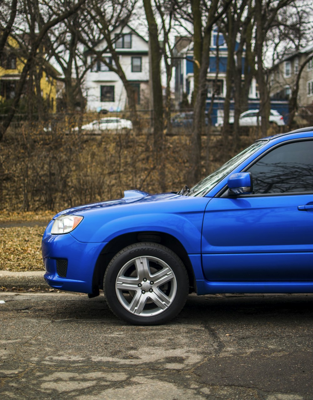 a blue car parked on the side of the road