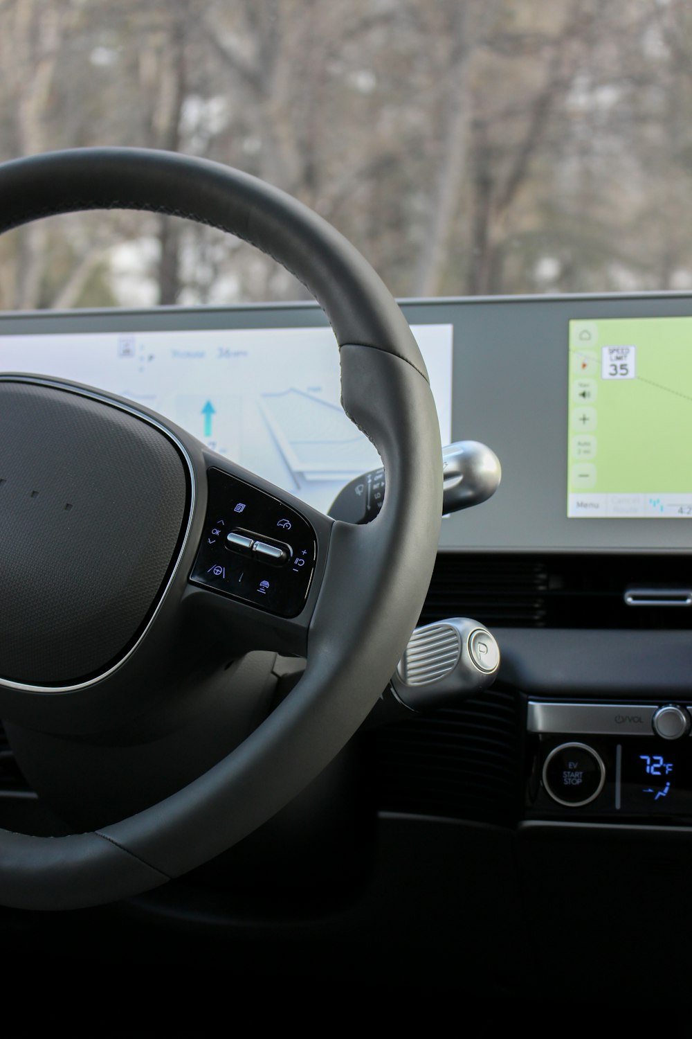 a car dashboard with a monitor and steering wheel