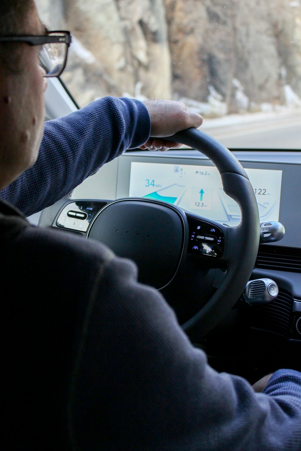 a man driving a car on a snowy road