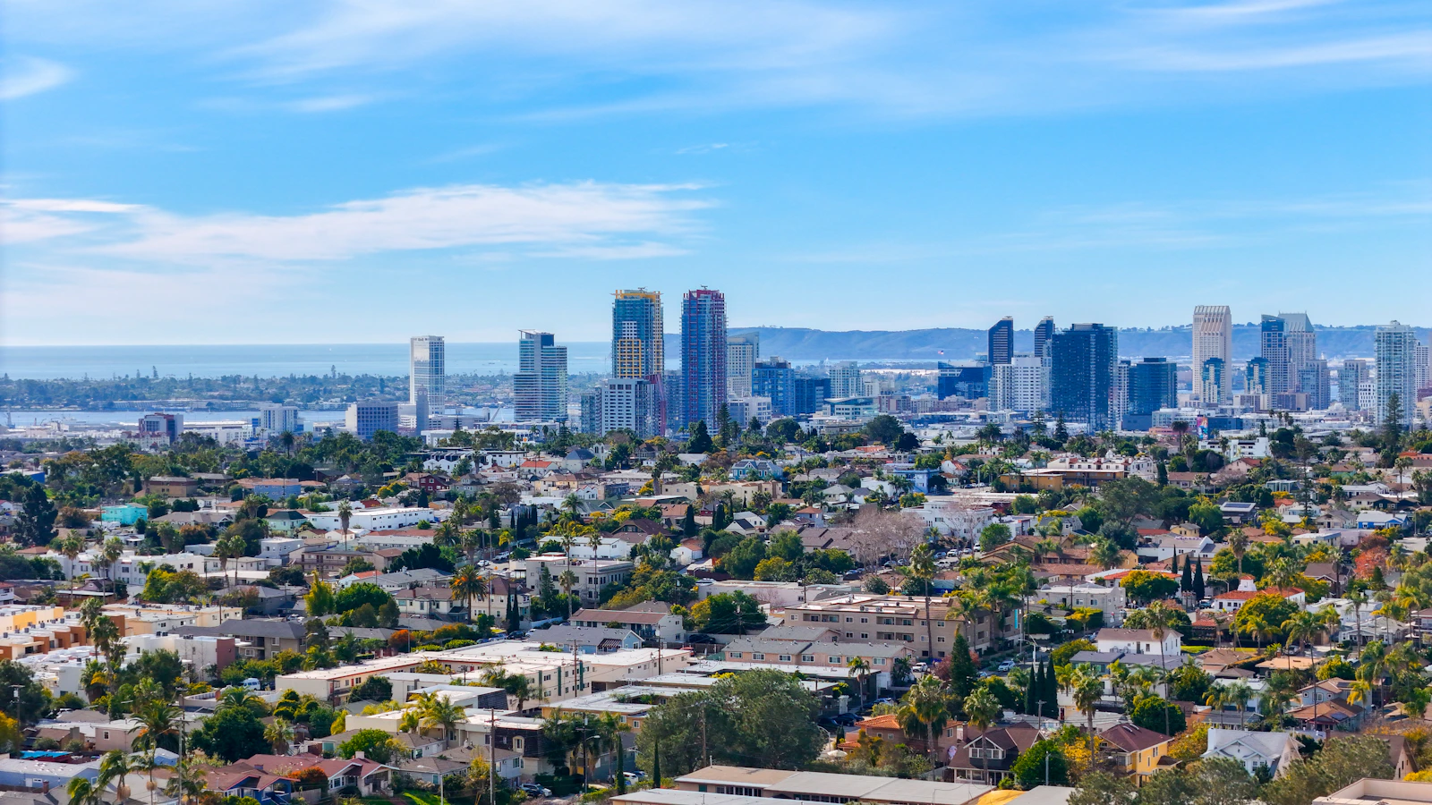 Downtown San Diego seen across the rooftops of a residential neighborhood on a clear day