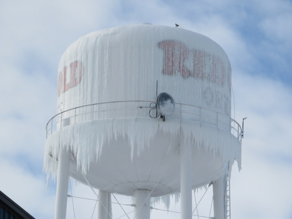 a water tower covered in ice and icicles