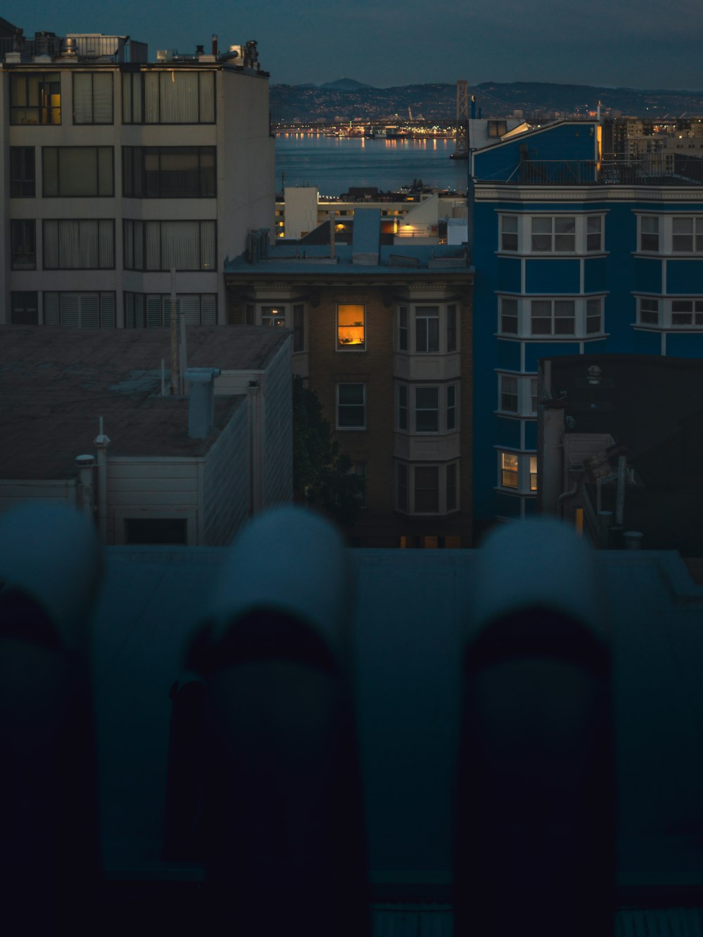 a view of a city at night from a rooftop