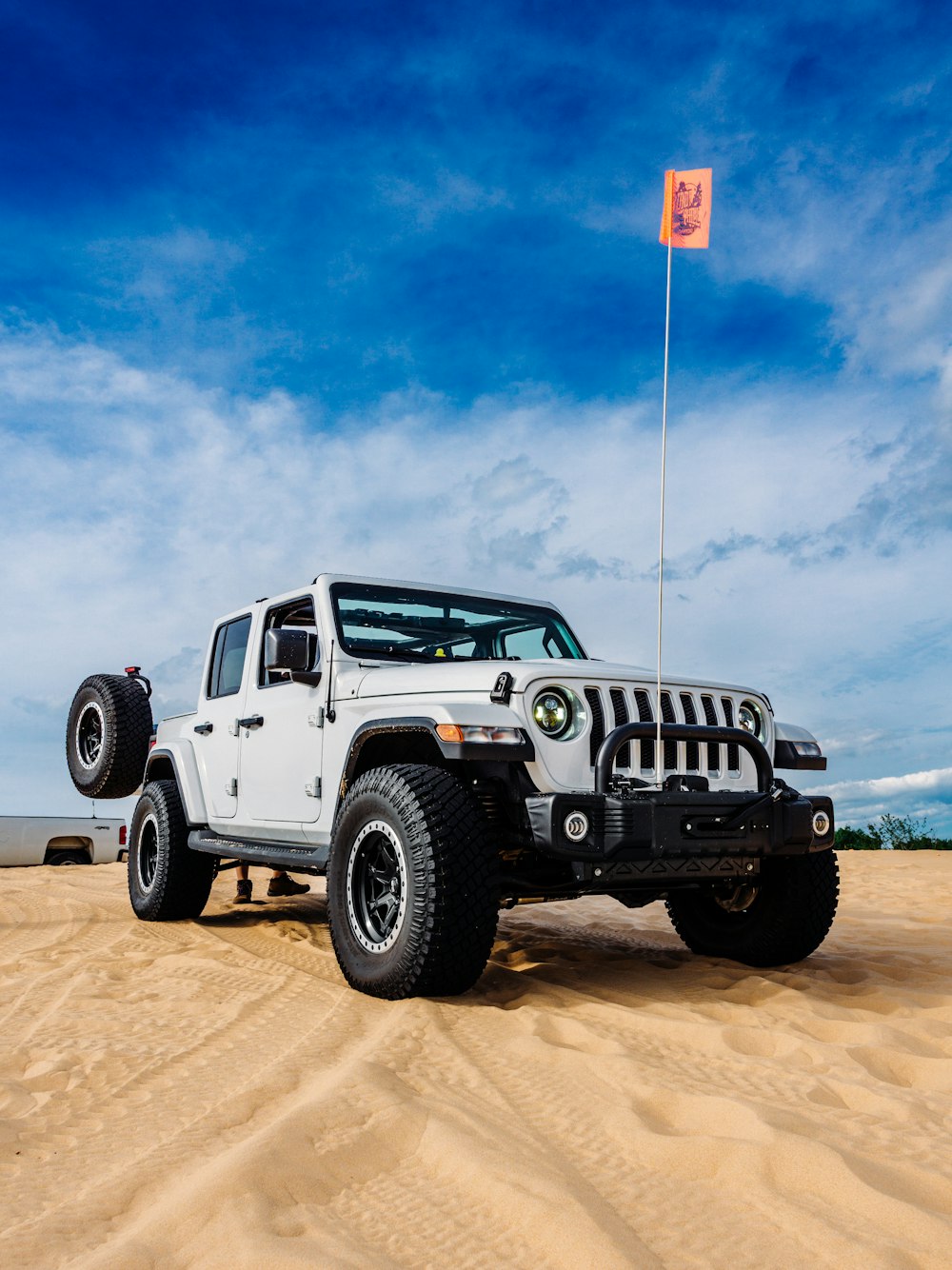 Un jeep blanco con una bandera encima