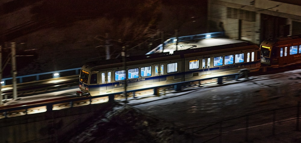 a train traveling down tracks next to a building