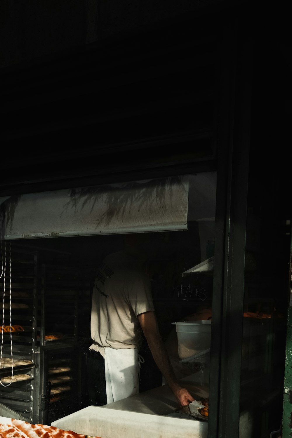 a man standing in front of a pizza oven
