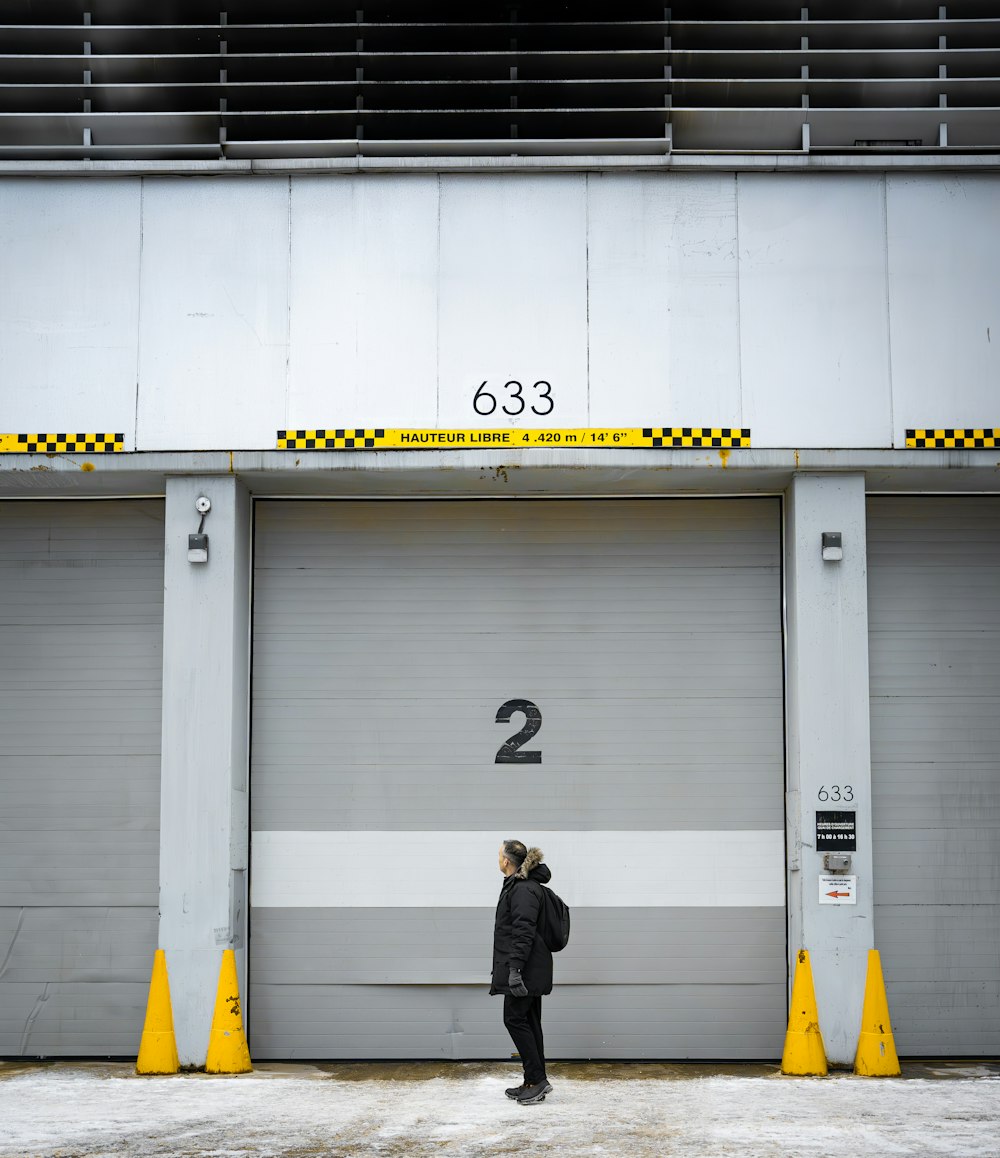 a man standing in front of a garage door