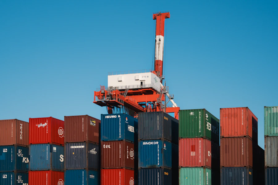 A crane lifting shipping containers at an Indian port, the final step in the export supply chain to the USA and UK