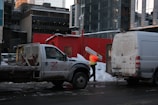 a man standing next to a truck in the snow