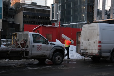 a man standing next to a truck in the snow