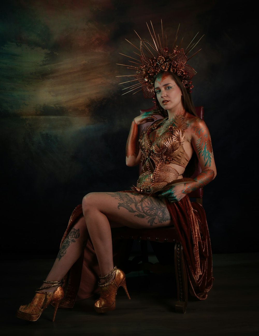 a woman with tattoos sitting on a chair