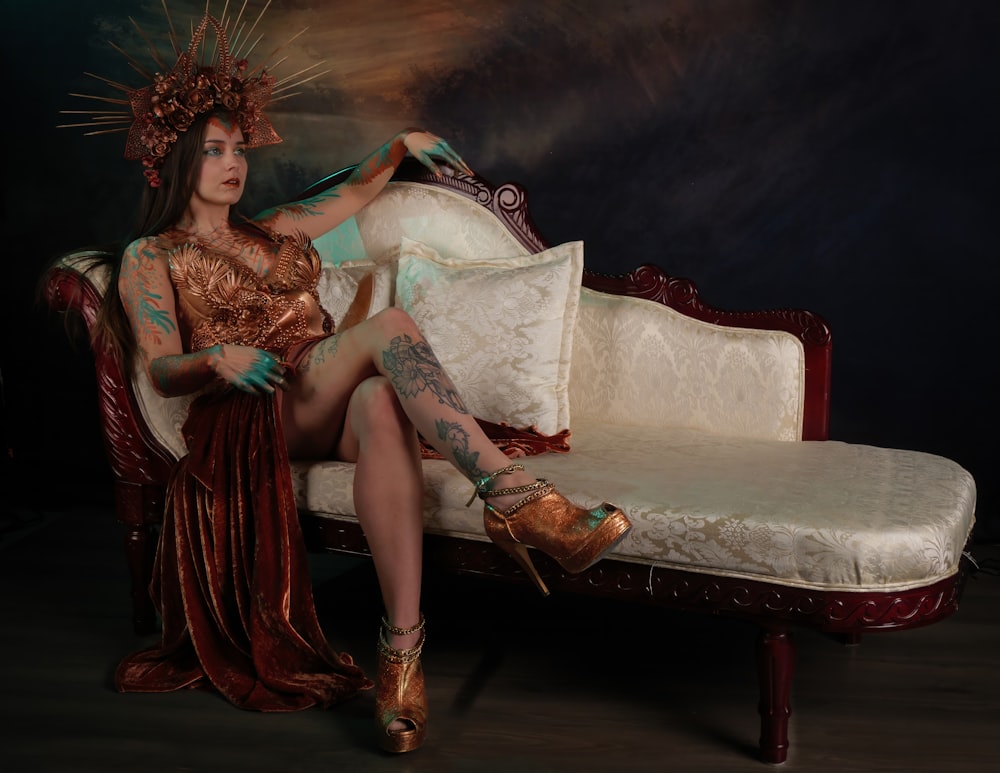 a woman with tattoos sitting on a couch