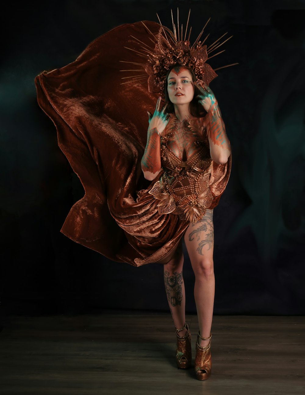 a woman in a brown dress with tattoos on her body