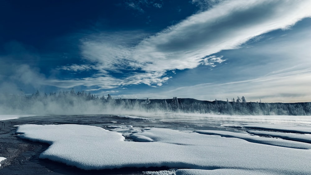 a large body of water surrounded by snow