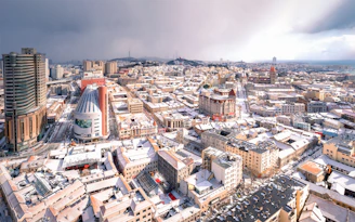 an aerial view of a city with tall buildings