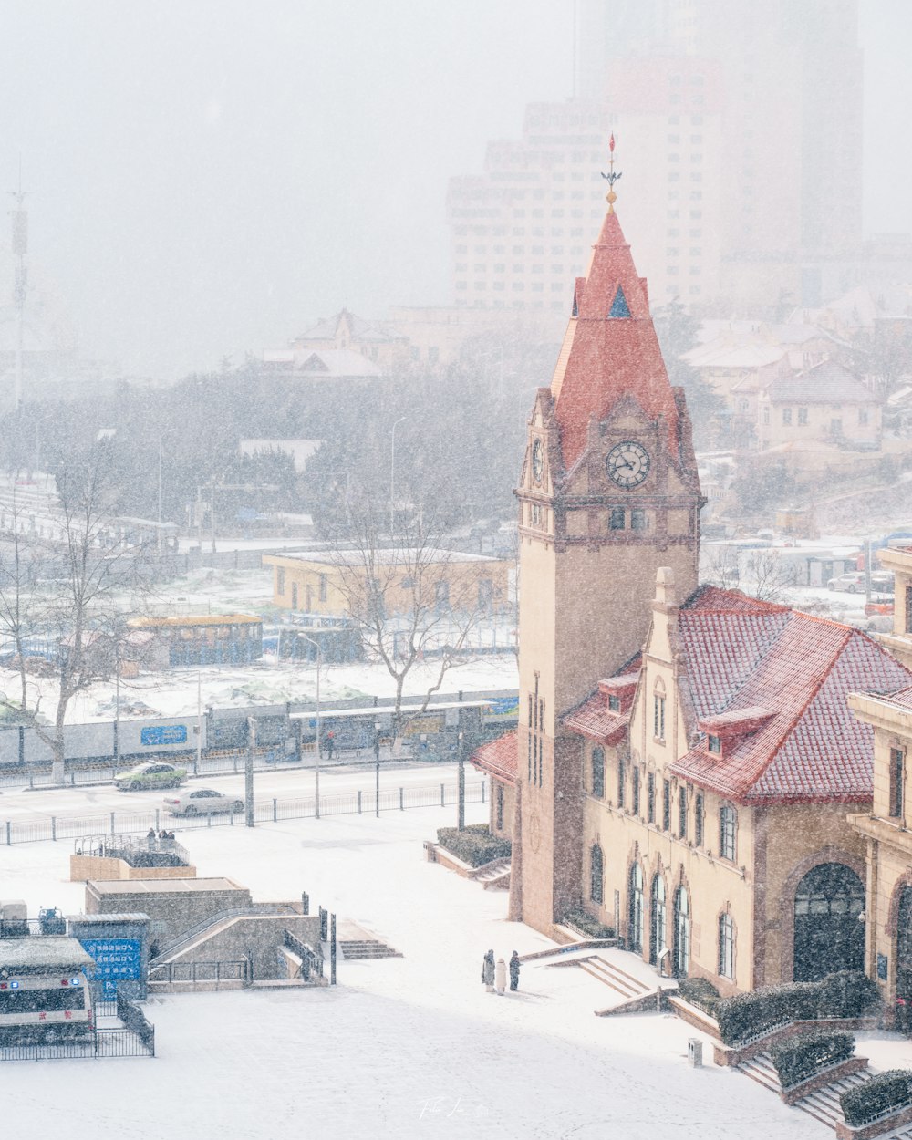 a clock tower in the middle of a snowy city