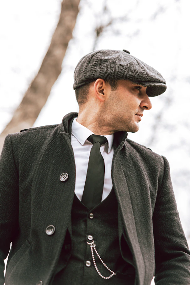 a man in a suit and tie wearing a hat