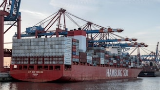 a large red and white container ship in the water