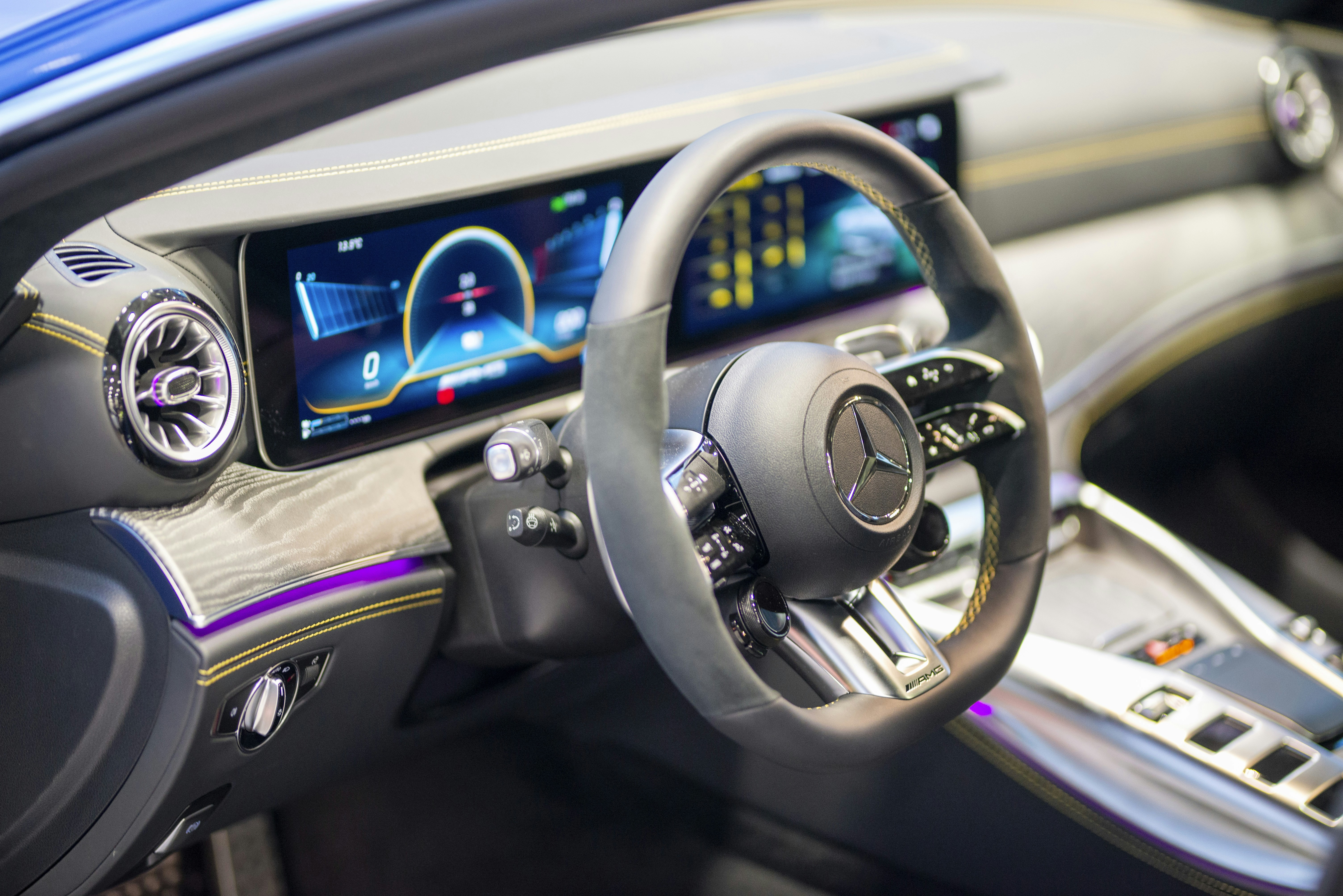 a car dashboard with a steering wheel and a dash board