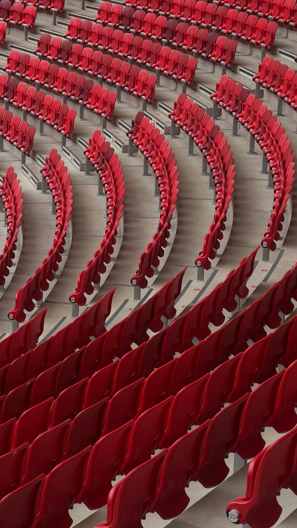a row of red seats in a stadium