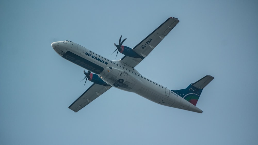 a large passenger plane flying through a blue sky