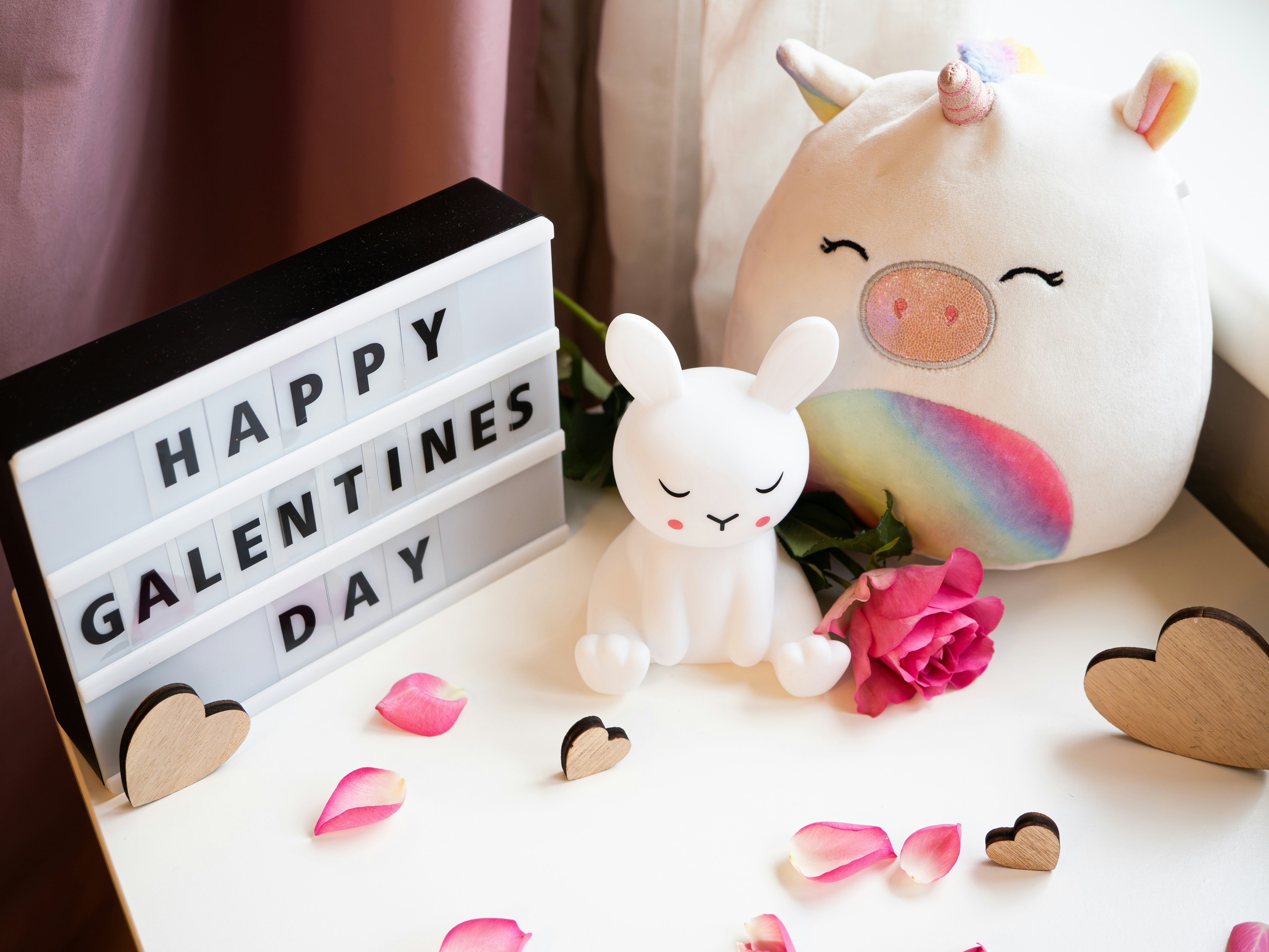 a stuffed animal next to a sign that says happy valentine's day