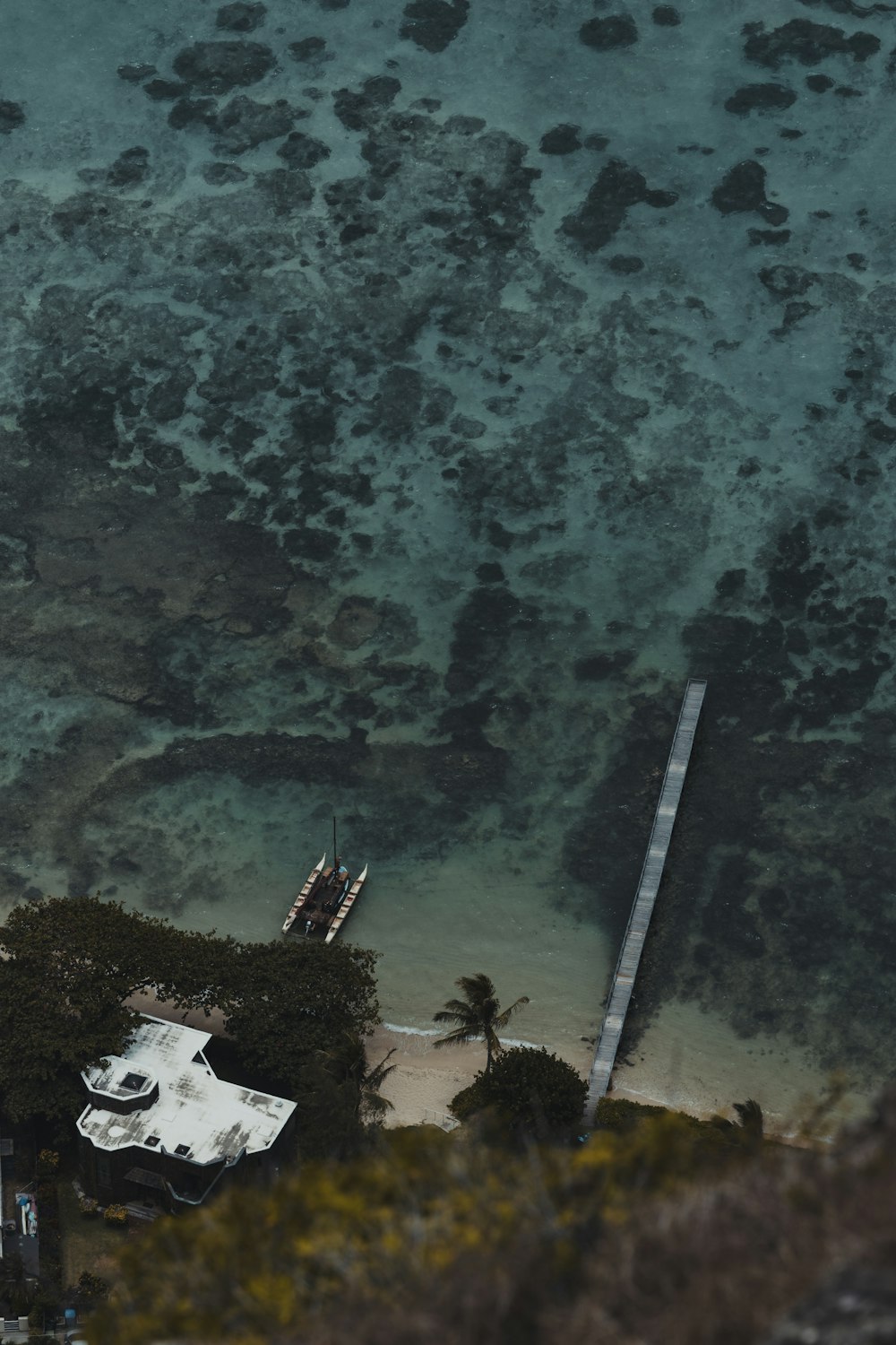 an aerial view of a beach and a pier