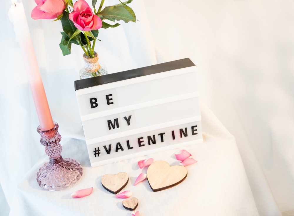 a sign that says be my valentine on a table