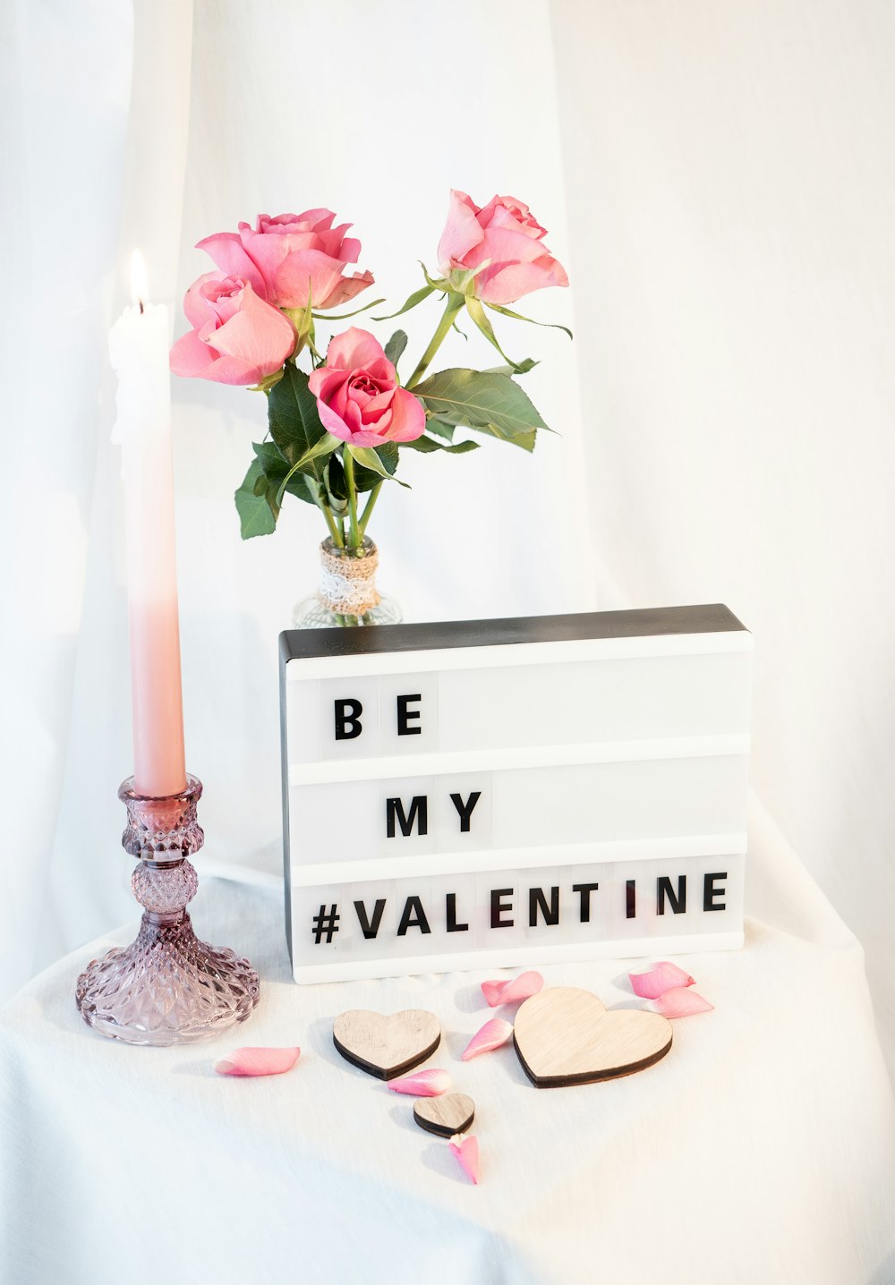 a vase of roses and a sign that says be my valentine