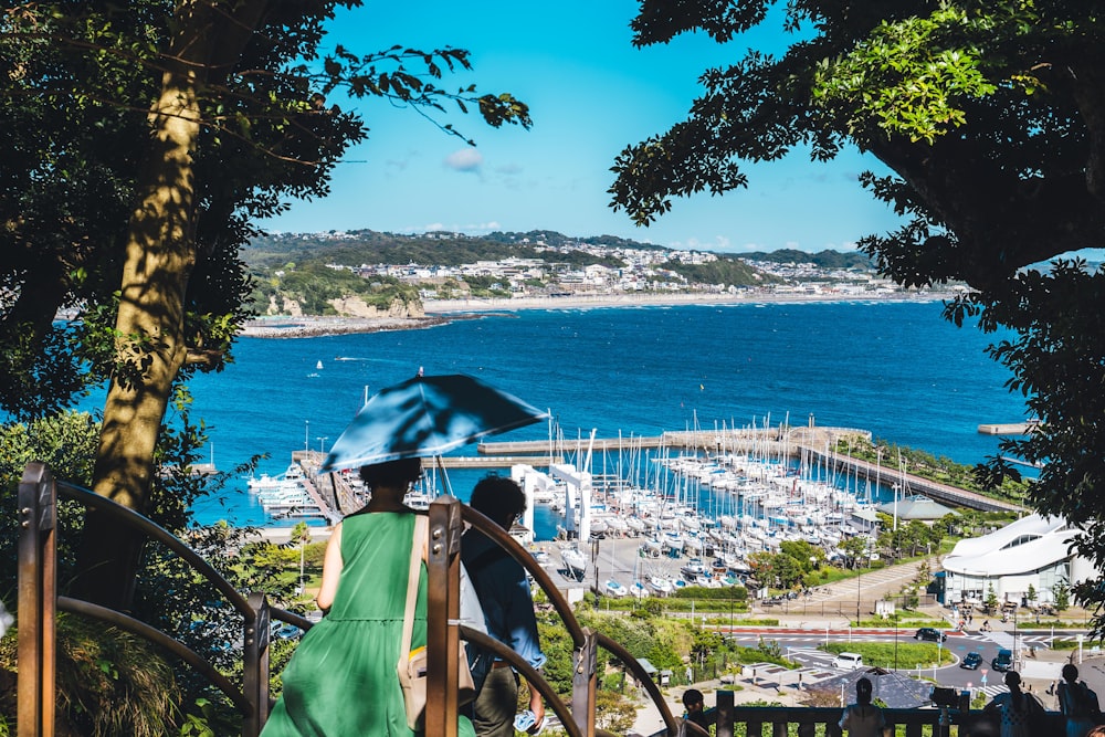 a person with an umbrella walking up a set of stairs