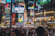 a crowded city street filled with lots of people