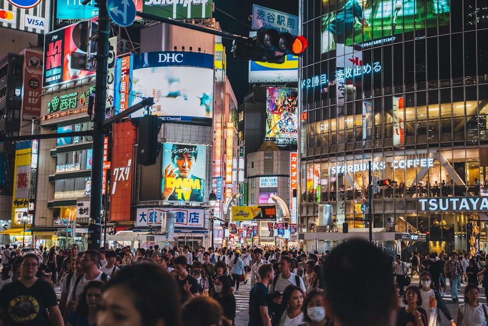 a crowded city street filled with lots of people