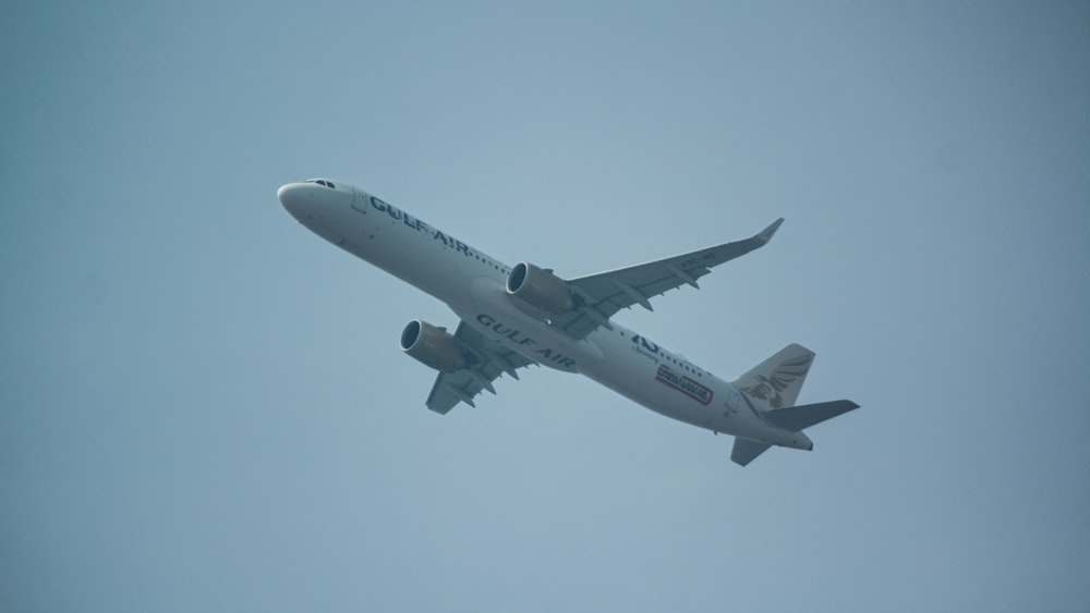 a large jetliner flying through a blue sky